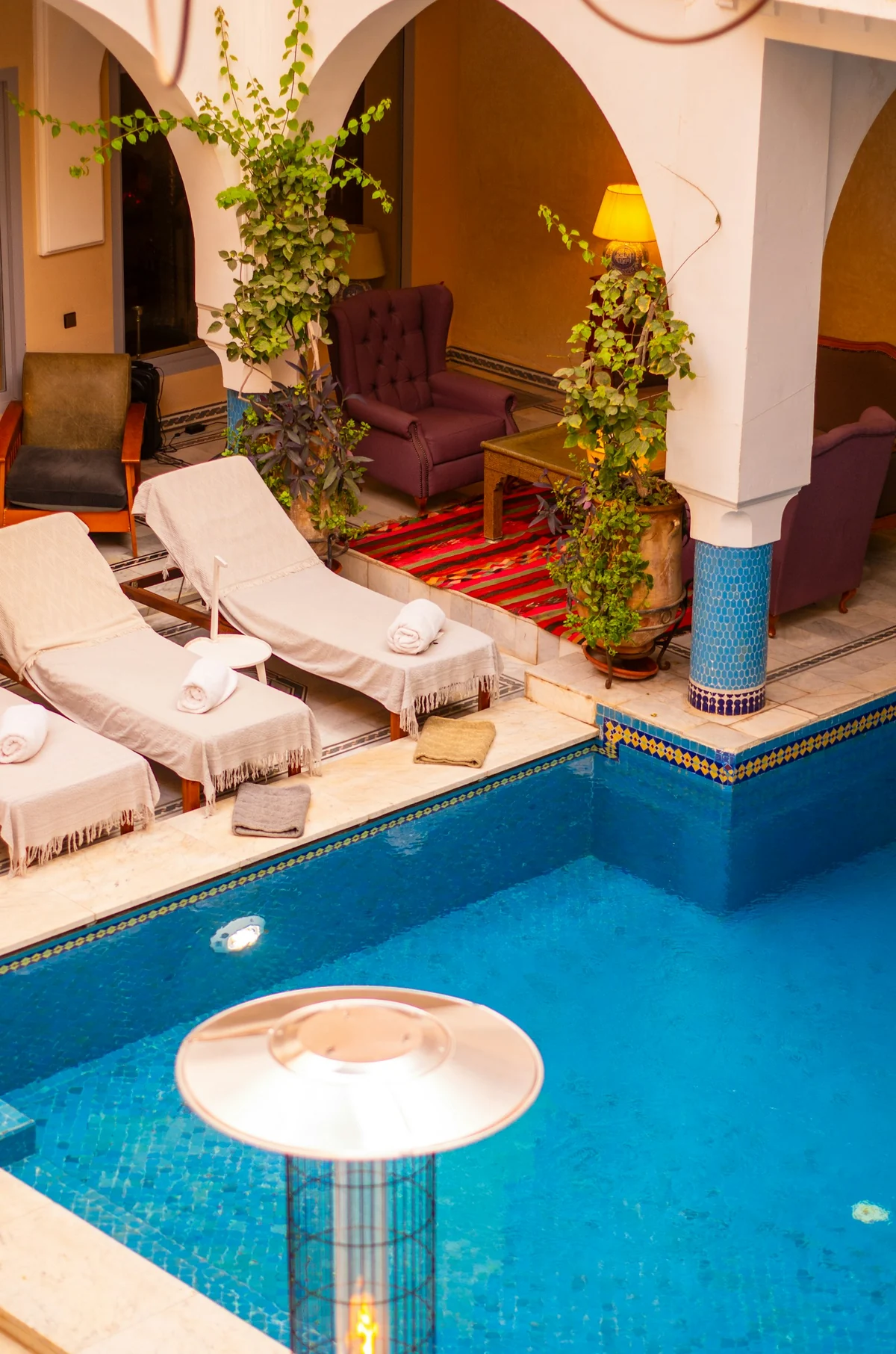 Luxury Moroccan courtyard pool prepared with loungers and towels