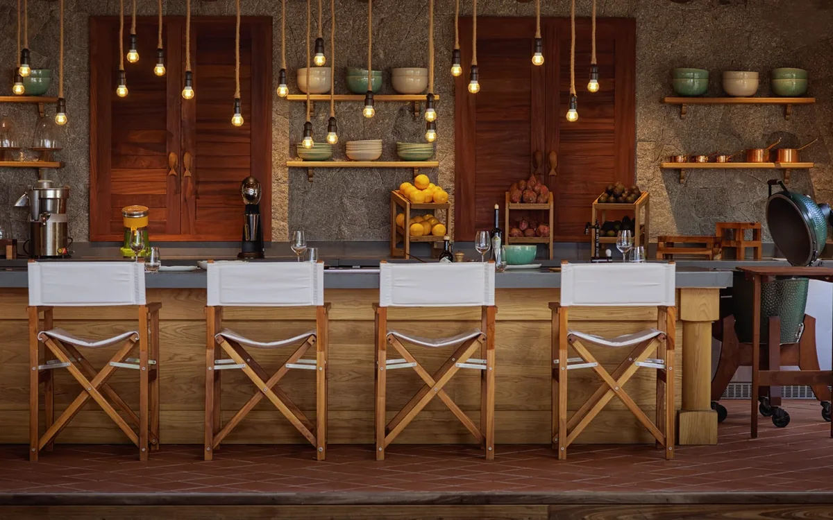 Chef's table with warm pendant lights and prepared seating