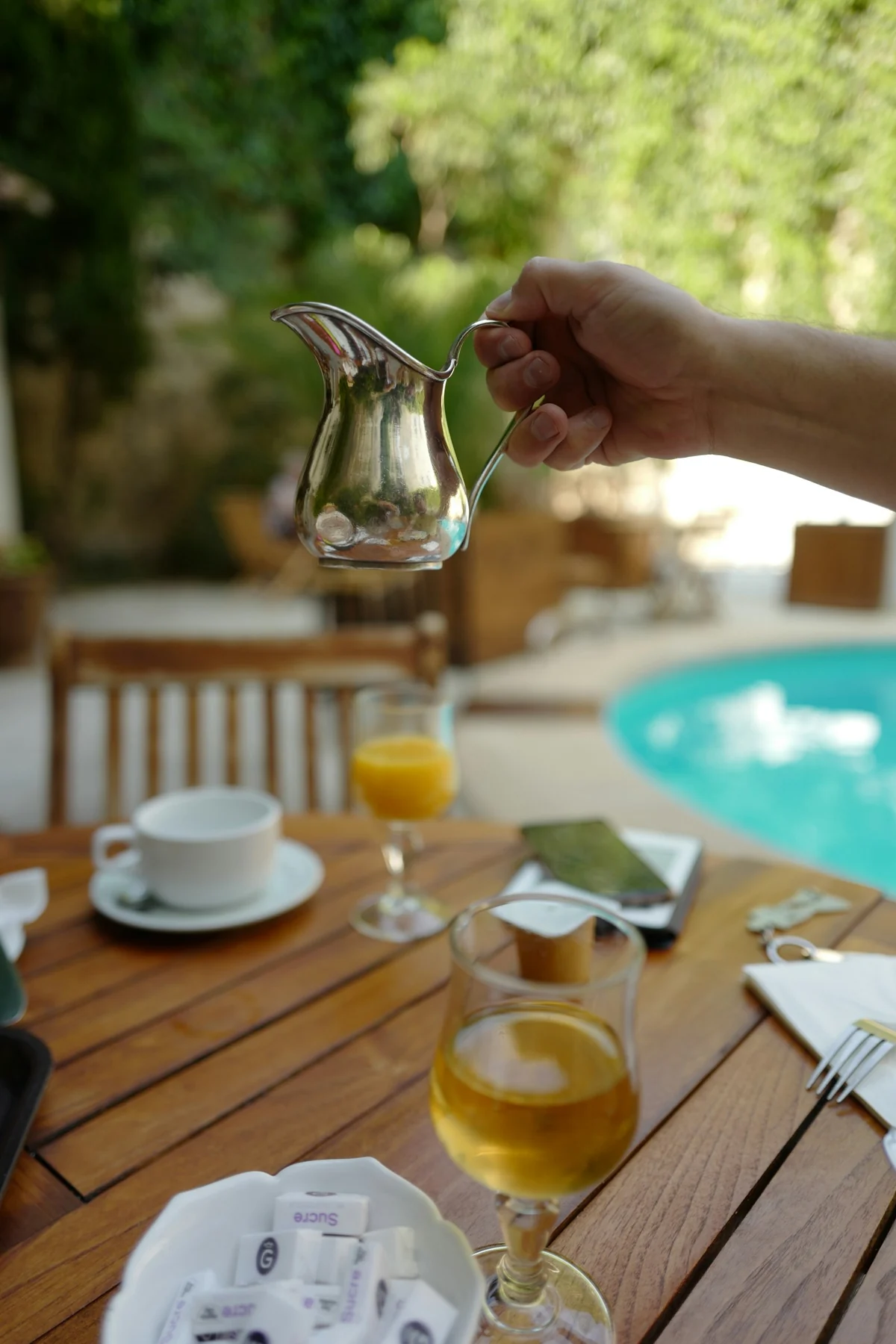 Private villa service preparing fresh fruit juice by the pool